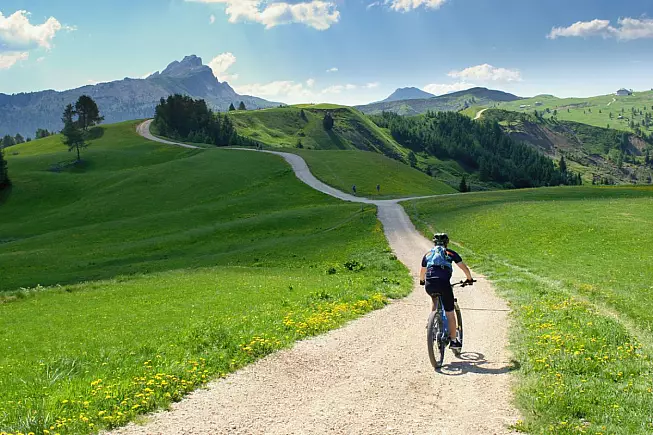 Biker su bicicletta in un paesaggio delle Dolomiti